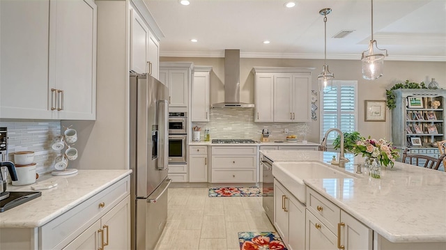1114 Bearing Ct, Bradenton, FL 34208 - kitchen with appliances with stainless steel finishes, wall chimney range hood, backsplash, a center island with sink, and ornamental molding