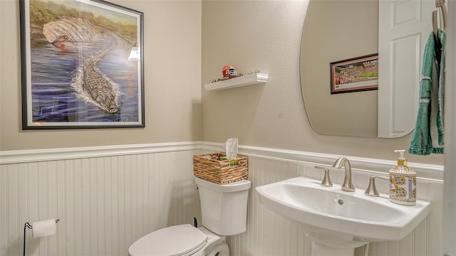 1114 Bearing Ct, Bradenton, FL 34208 - half bathroom with a wainscoted wall and a sink
