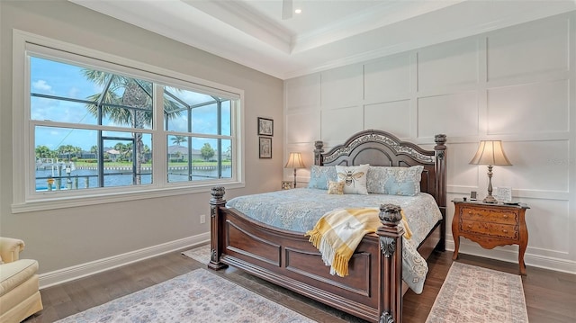 1114 Bearing Ct, Bradenton, FL 34208 - bedroom featuring ornamental molding, dark wood finished floors, a water view, and a tray ceiling