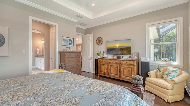 1114 Bearing Ct, Bradenton, FL 34208 - bedroom with arched walkways, wood finished floors, crown molding, a tray ceiling, and connected bathroom
