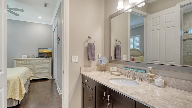 1114 Bearing Ct, Bradenton, FL 34208 - ensuite bathroom with ornamental molding, vanity, a ceiling fan, and wood finished floors