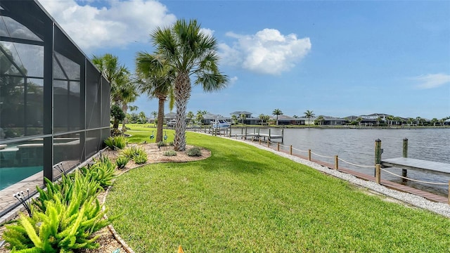 1114 Bearing Ct, Bradenton, FL 34208 - view of green lawn featuring a dock, a water view, glass enclosure, and a residential view