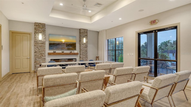 1114 Bearing Ct, Bradenton, FL 34208 - living area featuring a ceiling fan, light wood-type flooring, recessed lighting, a tray ceiling, and a fireplace