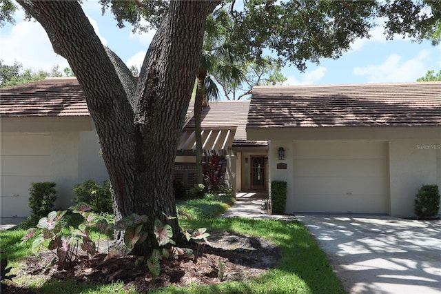 3376 Sandleheath Unit 9, Sarasota, FL 34235 - view of front of property featuring concrete driveway, an attached garage, and stucco siding
