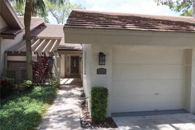 3376 Sandleheath Unit 9, Sarasota, FL 34235 - property entrance with stucco siding and a tile roof