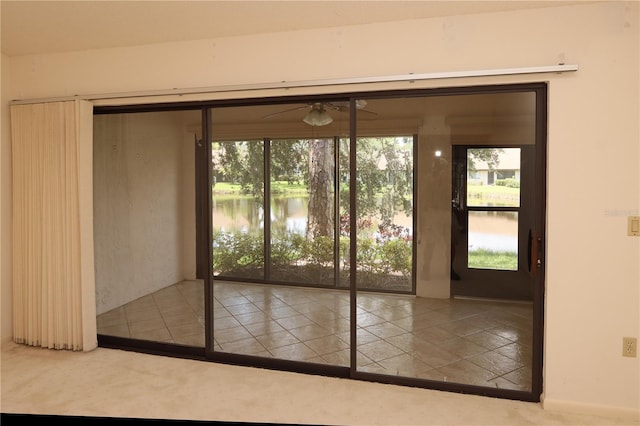 3376 Sandleheath Unit 9, Sarasota, FL 34235 - entryway featuring healthy amount of natural light, ceiling fan, tile patterned flooring, and a water view