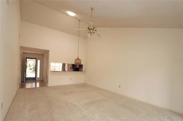 3376 Sandleheath Unit 9, Sarasota, FL 34235 - unfurnished living room with carpet flooring, high vaulted ceiling, and ceiling fan