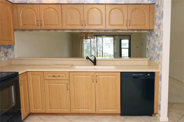 3376 Sandleheath Unit 9, Sarasota, FL 34235 - kitchen featuring black appliances, light countertops, wallpapered walls, light tile patterned flooring, and light brown cabinetry