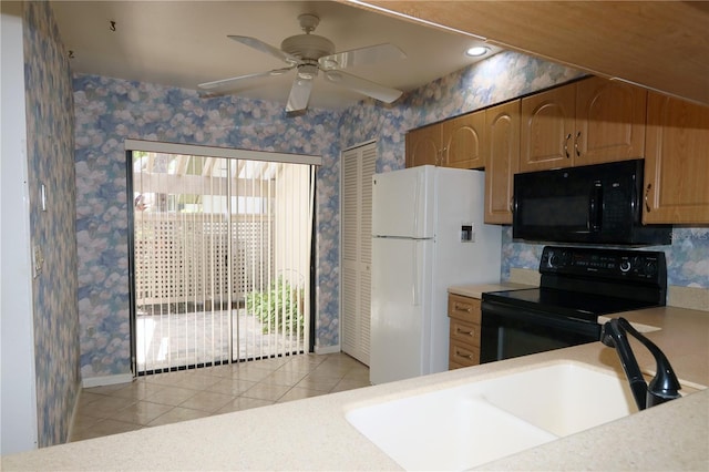 3376 Sandleheath Unit 9, Sarasota, FL 34235 - kitchen featuring black appliances, light tile patterned floors, wallpapered walls, light countertops, and a ceiling fan