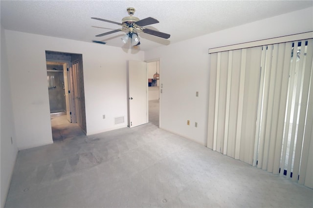3376 Sandleheath Unit 9, Sarasota, FL 34235 - unfurnished bedroom with carpet, a textured ceiling, and ceiling fan