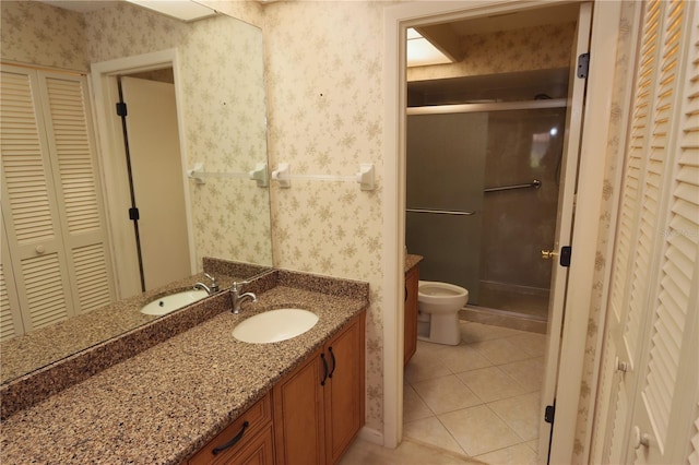 3376 Sandleheath Unit 9, Sarasota, FL 34235 - full bath featuring a closet, wallpapered walls, tile patterned flooring, vanity, and a stall shower