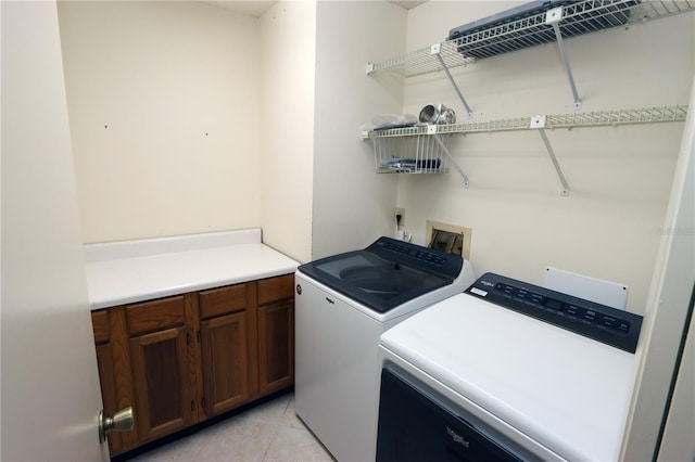 3376 Sandleheath Unit 9, Sarasota, FL 34235 - laundry area with independent washer and dryer and light tile patterned floors