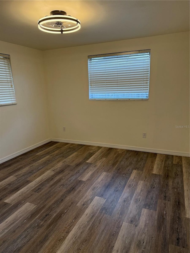 4424 Coco Ridge Cir, Sarasota, FL 34233 - unfurnished room with dark wood-type flooring and baseboards