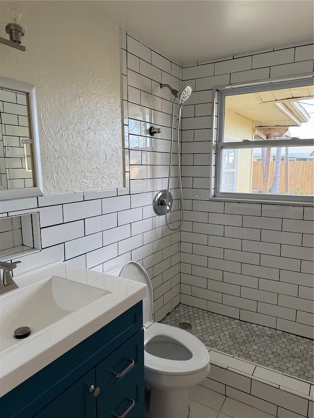 4424 Coco Ridge Cir, Sarasota, FL 34233 - bathroom featuring a shower stall, vanity, tile walls, and a textured wall