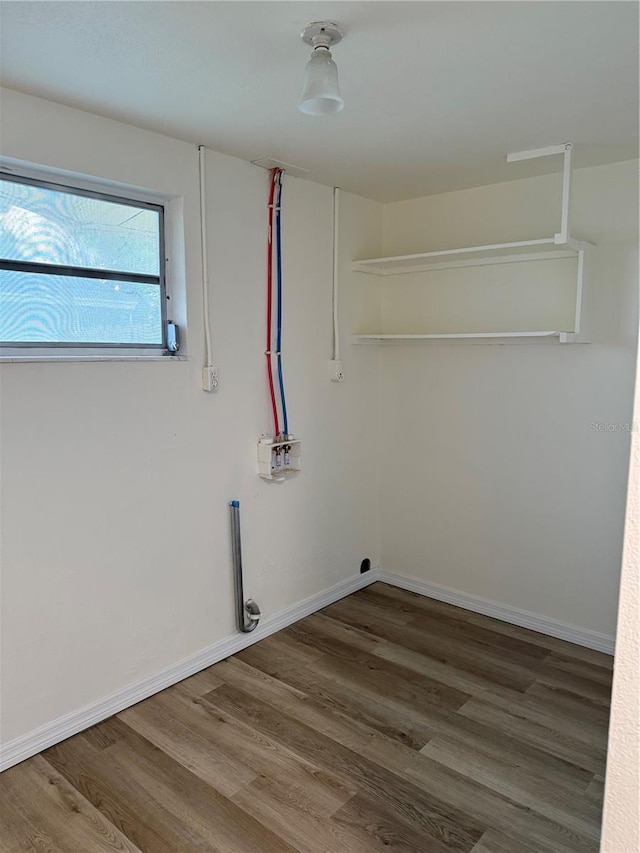 4424 Coco Ridge Cir, Sarasota, FL 34233 - laundry area with wood finished floors and baseboards