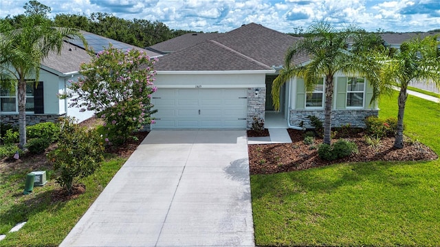 13829 Camden Crest Ter, Bradenton, FL 34211 - single story home with stone siding, a garage, a front yard, and concrete driveway