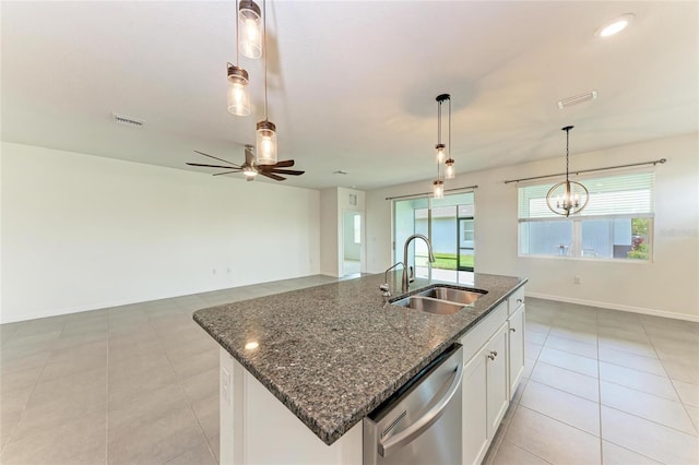 13829 Camden Crest Ter, Bradenton, FL 34211 - kitchen with dishwasher, ceiling fan, light tile patterned floors, dark stone counters, and decorative light fixtures