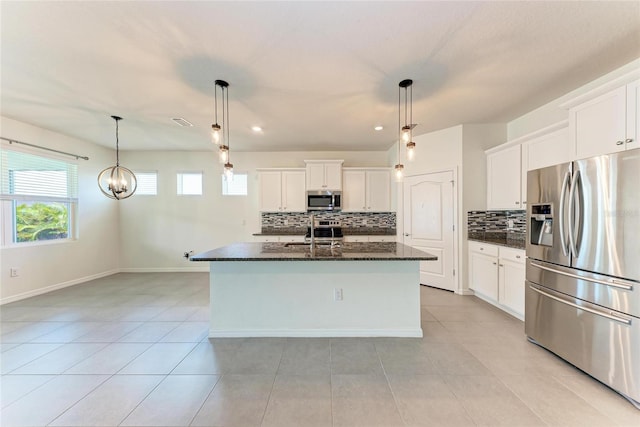 13829 Camden Crest Ter, Bradenton, FL 34211 - kitchen featuring appliances with stainless steel finishes, tasteful backsplash, dark stone countertops, white cabinets, and recessed lighting