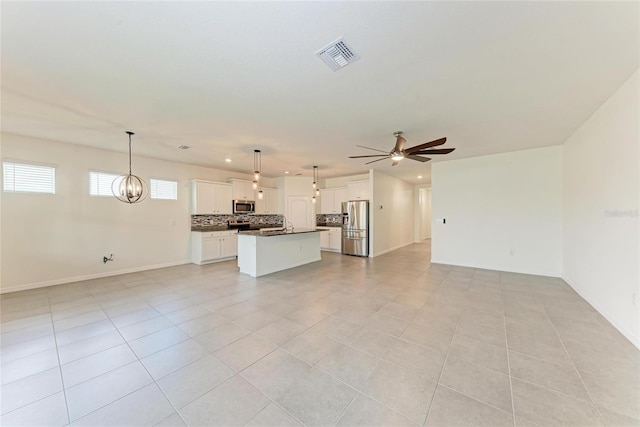 13829 Camden Crest Ter, Bradenton, FL 34211 - unfurnished living room featuring ceiling fan, light tile patterned floors, and a chandelier