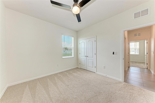 13829 Camden Crest Ter, Bradenton, FL 34211 - unfurnished bedroom featuring light colored carpet, multiple windows, a closet, and ceiling fan