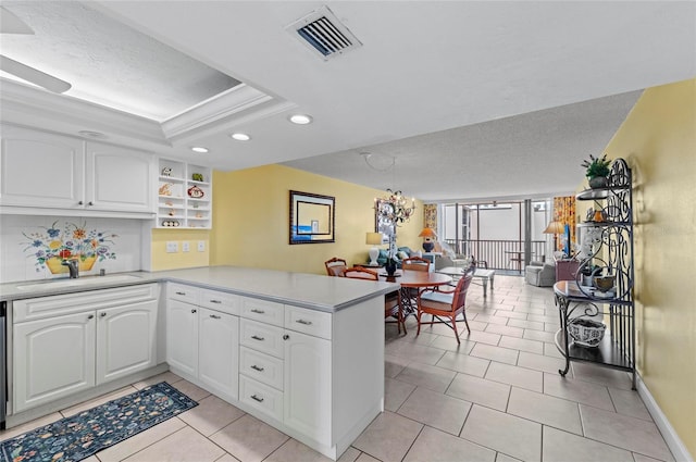 6480 Midnight Pass Rd Unit 503, Sarasota, FL 34242 - kitchen featuring a peninsula, recessed lighting, white cabinetry, light countertops, and light tile patterned floors