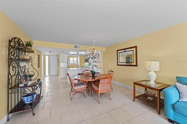 6480 Midnight Pass Rd Unit 503, Sarasota, FL 34242 - dining room featuring a textured ceiling, light tile patterned flooring, and a chandelier