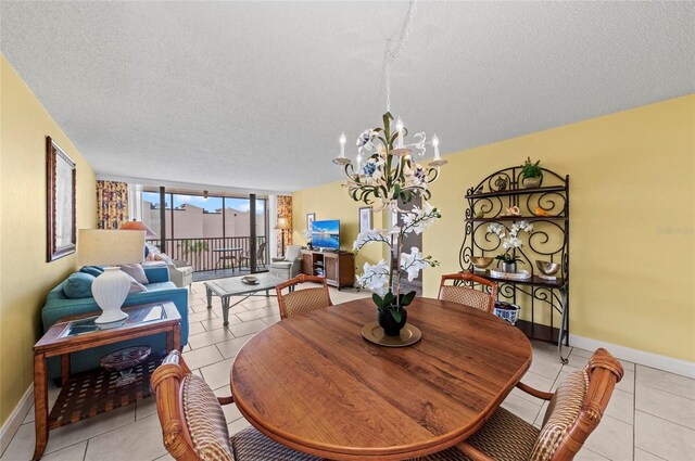 6480 Midnight Pass Rd Unit 503, Sarasota, FL 34242 - dining room with a chandelier, a textured ceiling, and light tile patterned floors