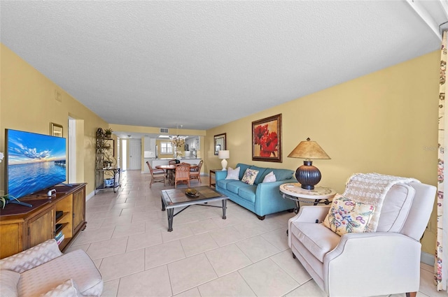 6480 Midnight Pass Rd Unit 503, Sarasota, FL 34242 - living room featuring a chandelier, a textured ceiling, and light tile patterned flooring
