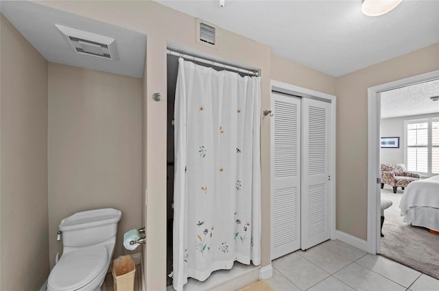 6480 Midnight Pass Rd Unit 503, Sarasota, FL 34242 - full bathroom featuring a closet, tile patterned floors, ensuite bath, and a textured ceiling