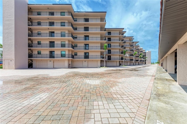 6480 Midnight Pass Rd Unit 503, Sarasota, FL 34242 - view of apartment building / complex with a garage and driveway