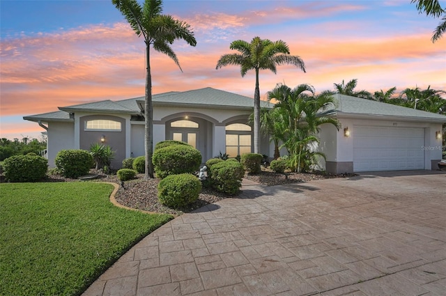 4173 Beach View Ct, Port Charlotte, FL 33948 - single story home with a front lawn, stucco siding, decorative driveway, and a garage