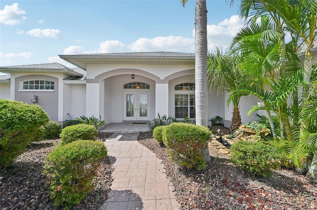 4173 Beach View Ct, Port Charlotte, FL 33948 - view of exterior entry with french doors, stucco siding, and covered porch