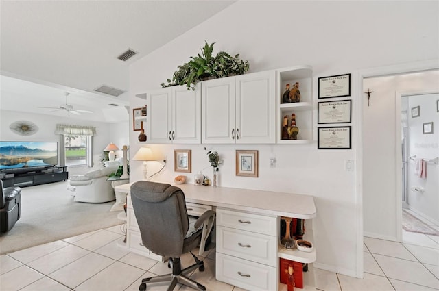 4173 Beach View Ct, Port Charlotte, FL 33948 - office area featuring light tile patterned floors, built in study area, a ceiling fan, vaulted ceiling, and light carpet