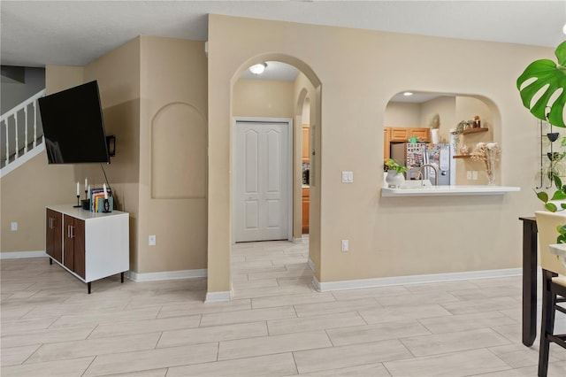 311 Cape Harbour Loop Unit 101, Bradenton, FL 34212 - living area with arched walkways, stairs, and wood finish floors