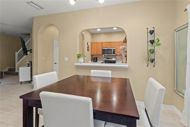 311 Cape Harbour Loop Unit 101, Bradenton, FL 34212 - dining room featuring arched walkways and stairway