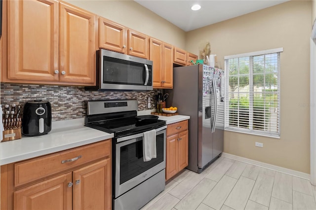 311 Cape Harbour Loop Unit 101, Bradenton, FL 34212 - kitchen with appliances with stainless steel finishes, decorative backsplash, light countertops, and recessed lighting