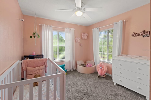 311 Cape Harbour Loop Unit 101, Bradenton, FL 34212 - carpeted bedroom with multiple windows, a crib, and ceiling fan