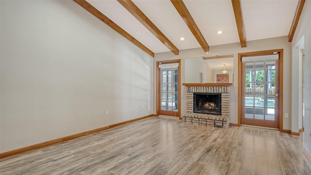 8103 11th Ave NW, Bradenton, FL 34209 - unfurnished living room featuring wood finished floors and a brick fireplace