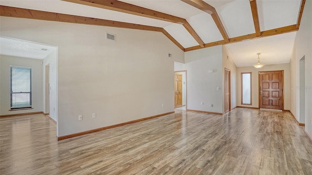 8103 11th Ave NW, Bradenton, FL 34209 - unfurnished living room with light wood-type flooring, high vaulted ceiling, and beam ceiling