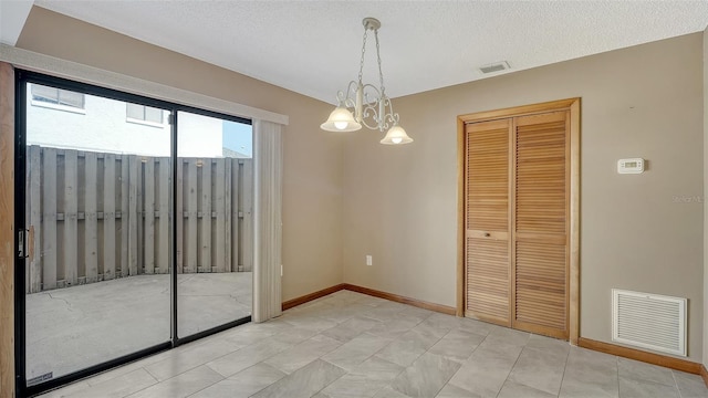 8103 11th Ave NW, Bradenton, FL 34209 - unfurnished dining area featuring a chandelier and a textured ceiling