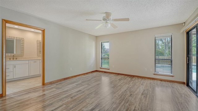 8103 11th Ave NW, Bradenton, FL 34209 - spare room featuring light wood-type flooring, a textured ceiling, and ceiling fan