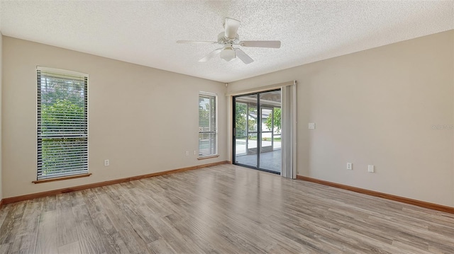 8103 11th Ave NW, Bradenton, FL 34209 - empty room with light wood-style flooring, plenty of natural light, a textured ceiling, and ceiling fan