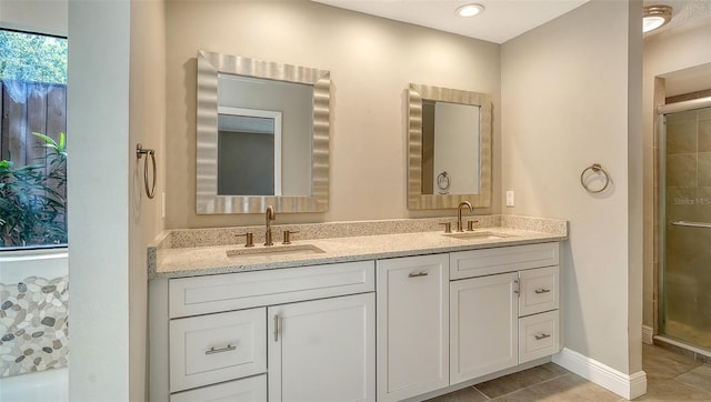 8103 11th Ave NW, Bradenton, FL 34209 - full bathroom with a shower stall, double vanity, and tile patterned flooring