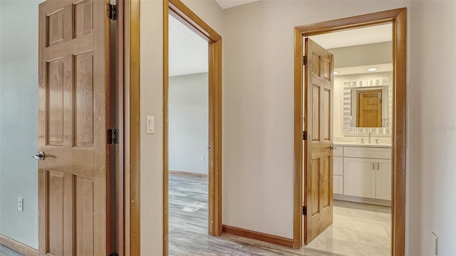 8103 11th Ave NW, Bradenton, FL 34209 - hall featuring a sink and light wood-type flooring