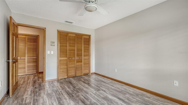 8103 11th Ave NW, Bradenton, FL 34209 - unfurnished bedroom featuring wood finished floors, a closet, and a ceiling fan