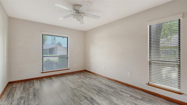 8103 11th Ave NW, Bradenton, FL 34209 - empty room featuring light wood-style floors, ceiling fan, and a textured ceiling