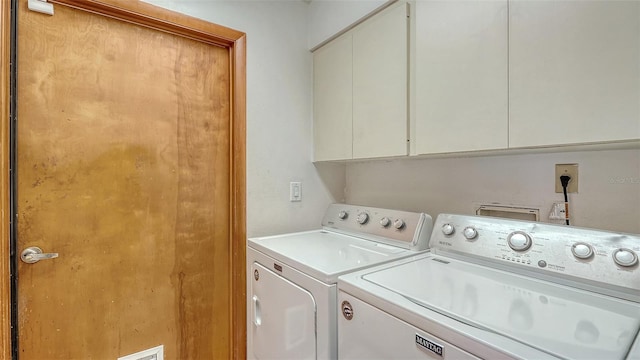 8103 11th Ave NW, Bradenton, FL 34209 - laundry room featuring cabinet space and separate washer and dryer