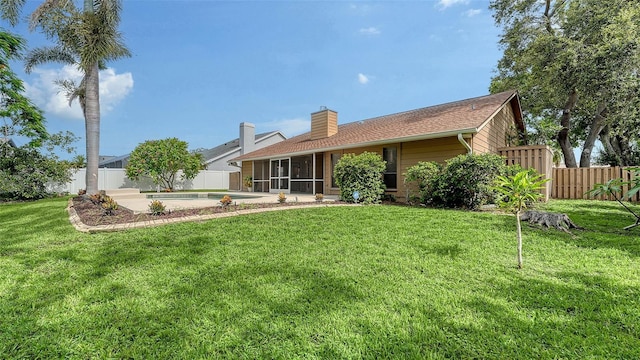 8103 11th Ave NW, Bradenton, FL 34209 - back of house with a sunroom, a fenced backyard, and a chimney