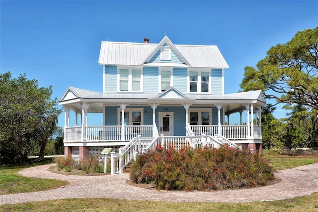 8103 11th Ave NW, Bradenton, FL 34209 - view of front of property featuring a porch, stairway, a metal roof, and a chimney