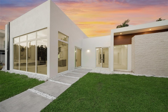 3500 Bay Shore Rd, Sarasota, FL 34234 - property entrance with stucco siding and a yard